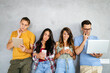 © NDABCREATIVITY - Happy young people working, using digital devices. Technology, people concept.