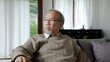 © ChayTee - Asian elderly senior male or depressed grandpa at nursing home living room on quarantine looking out window feeling sad missing unhappy thoughtful in mental health care in older people.