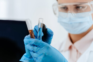 close up. female scientist marks tubes with tests.