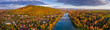 Tokaj, Hungary - Ultra wide aerial panoramic view of the small town of Tokaj with golden vineyards on the hills of wine region on a warm sunny autumn morning. River Tisza and blue sky and clouds