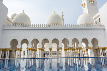 Wall Mural - Architectural details of  White Grand Mosque built with marble stone against cloudy sky, also called Sheikh Zayed Grand Mosque in Abu Dhabi, UAE