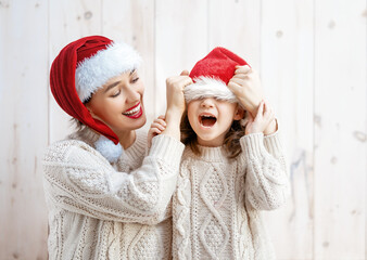 Wall Mural - girl and her mother in Santa's hats