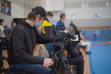 masked operator shoots a stream. Sports event