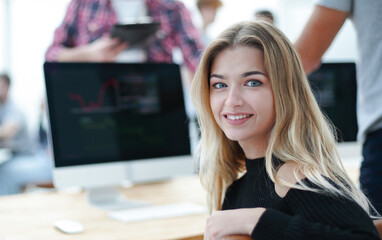 young woman sitting at an office Desk.