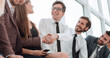 © ASDF - young business colleagues shaking hands. business concept