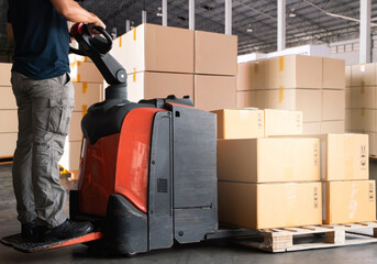 Wall Mural - Warehouse worker working with electric forklift pallet jack unloading package boxes on pallet at the warehouse.Cargo shipment boxes, Packaging, Warehousing storage.