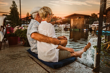 Wall Mural - Senior couple enjoying a evening in the cottage near the river