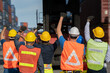 © Me studio - Group of people worker protesting in factory . Male  group of protestors fists raised up in the air.Logistics and transportation business Containers import export concept .