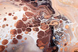 Fluid Art. Abstract marble background or texture. Waves and bubbles in warm natural colors