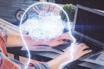 Man with computer background with brain theme hologram. Concept of brainstorm. Double exposure.