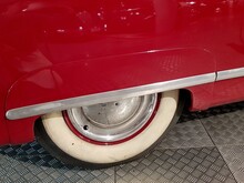 Cropped Image Of Red Car Parked On Diamond Plates