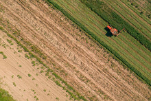 Aerial View Of Agricultural Tractor Harvesting Alfalfa Crops