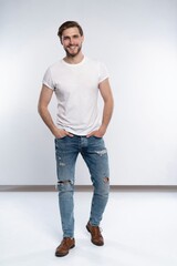 Canvas Print - Full length studio portrait of casual young man in jeans and shirt. Isolated on white background.