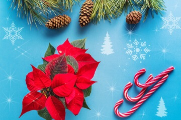 Festive Christmas and new year background with gift box and decorations on blue background.