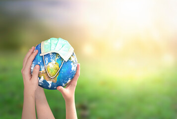 hands holding earth globe on natural background. elements of this image furnished by nasa