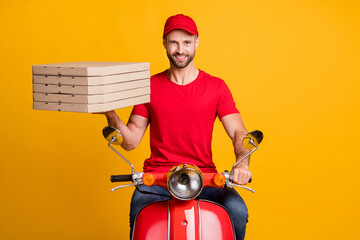 Wall Mural - Photo of delivery guy courier ride moped hold pile pizza boxes wear red t-shirt cap isolated yellow color background