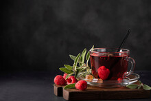 Hot Raspberry Tea With Sage And Honey In A Glass Mug