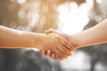 Wall Mural - concept health care and lifestyle,people handshake at outdoor.