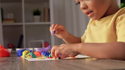 Poster - childhood, creativity and hobby concept - little african american girl with modeling clay playing at home