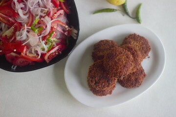 Wall Mural - Kerala style deep fried chicken cutlets served with onion tomato salad