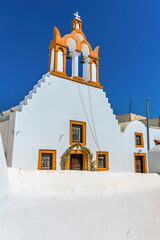 Wall Mural - A view of a church bell tower in the village of Emporio, Santorini in summertime