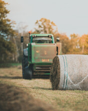 Tractor Making Bales In Field