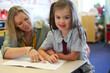 © Claire Bonnor/Austockphoto - School teacher helping child with her work