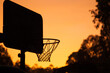 © Clare Seibel-Barnes/Austockphoto - Basketball net silhouette in a golden sunrise