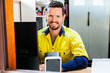© Clare Seibel-Barnes/Austockphoto - Happy male tradie at computer in home office