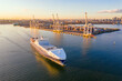 © Gary Chapman/Austockphoto - Aerial view of a cargo ship leaving a city port
