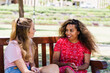 © Gillian Vann/Austockphoto - two young women chatting in the park