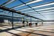 © Nicholas Gouldhurst/Austockphoto - Metal framework and workers on an industrial building site