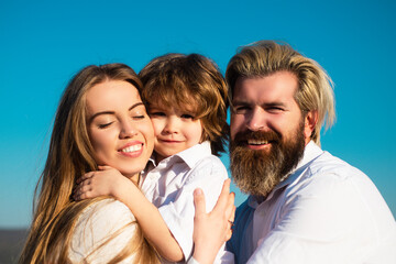 Wall Mural - Happy family, mother, father and children son embrace. Young smiling family with one child having fun together. Kids love and hug. Smile face.