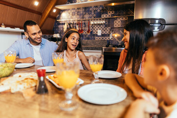 Wall Mural - Latin family having dinner at home