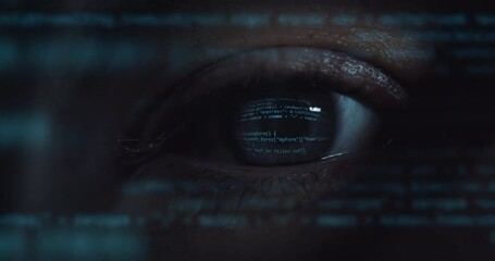 Cinematic macro of young programer's blu eye with latest innovative sophisticated technology display application with augmented reality holograms for realization of new codeproject.