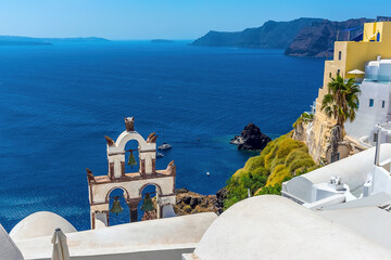 Wall Mural - A view from the village of Oia, Santorini past church bell towers in summertime