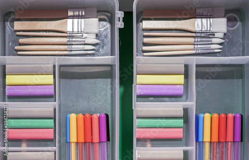 Fotomural Plastic pencil cases with colored crayons, brushes and felt-tip pens