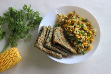 Wall Mural - Coriander paratha served with Scrambled egg, sweet corn and spring onions