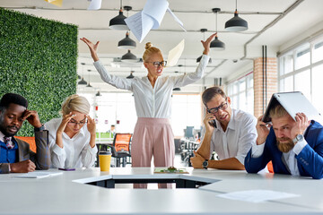 angry unbalanced female boss scream, scolds employees for not fulfilling the plan at work. frightene