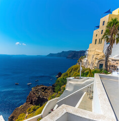Wall Mural - A view along the edge of the village of Oia, Santorini towards the caldera in summertime