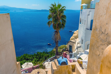 Wall Mural - A view down from the village of Oia, Santorini out into the caldera in summertime