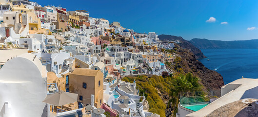 Wall Mural - The picturesque village of Oia, Santorini stretches out along the rim of the caldera in summertime