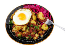 Corned Beef Hash Meal With A Crispy Fried Egg And Pickled Red Cabbage Isolated On A White Background