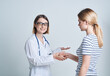© SHOTPRIME STUDIO - woman tells the doctor her health problems on a light background