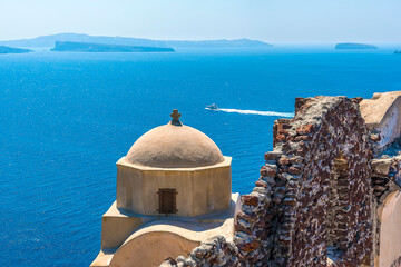 Wall Mural - A view past the castle out into the caldera from the village of Oia, Santorini in summertime