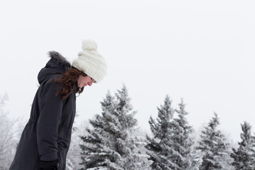 Girl walking in snow, frost and snow covered trees with fog, winter scene