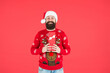 © be free - Thank you. new year party fun. celebrate winter holidays. merry christmas. man in funny knitted sweater with box. xmas shopping time. prepare gifts and presents. happy bearded man in santa claus hat