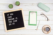 If you can dream it, you can do it. Letter board with motivational quote on white wooden background with notepad , pen, coffee and succulents. New year resolutions and goal setting mockup