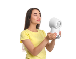 Poster - Woman enjoying air flow from portable fan on white background. Summer heat