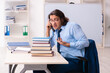 © Elnur - Young businessman student studying at workplace